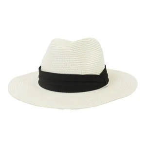 Close-up detail of the woven straw fedora hat featuring a black ribbon band and wide brim.