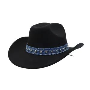 Close-up of black woolen cowboy hat with blue denim studded band and metallic rhinestone details.