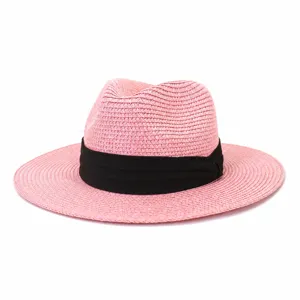 Pink straw fedora hat for summer outdoor beach sun protection with black ribbon band detail.
