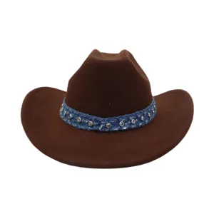 Close-up detail of a brown wool felt cowboy hat featuring a sparkling rhinestone blue denim band.