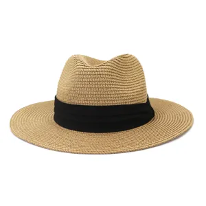 Detail shot of woven straw fedora sun hat with black band for beach and outdoor summer use