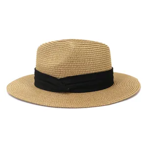 Detailed view of stylish woven straw sun hat featuring a black band for summer beach.