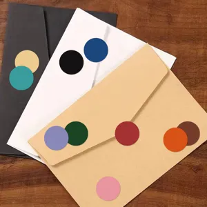 Round dot sticker detail shot showcasing colorful adhesive labels applied on paper envelopes nicely.