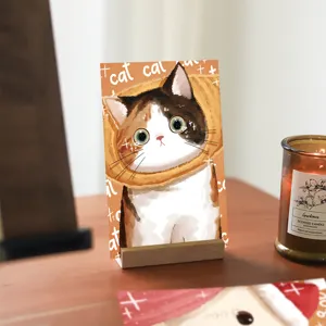 Cute cartoon calico cat postcard detail display on wooden stand, perfect for cute stationery gift.