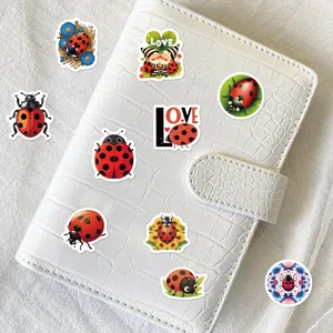 Cute cartoon ladybug stickers displayed on a white notebook, perfect for journal decor.