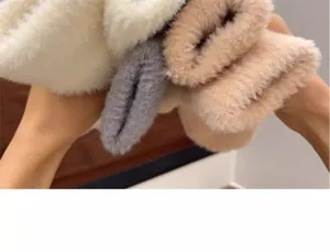 Close-up of soft fluffy winter plush gloves in multiple cozy colors, warm fleece texture.