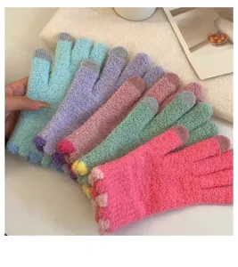 Close-up detail of soft colorful fuzzy knitted winter gloves, macaron shades, touch screen friendly.