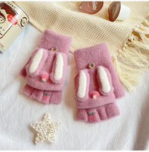 Detail shot of cute women's winter half-finger plush gloves featuring fuzzy rabbit ears.