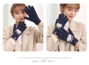 Close-up of cute cat paw knit winter gloves in dark blue, warm plush full fingers.