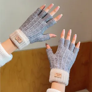 Detailed shot of half-finger knit gloves in grey and beige with cuffs. Perfect close-up.
