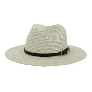 Close-up detail of the black belt strap and gold metal buckle on the straw fedora hat.