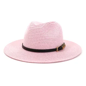 Close-up view of the pink woven straw hat showing fine texture and stylish black buckle belt.