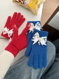 Winter warm knit gloves for women with cute lace bow and pearl, cozy touch screen design.