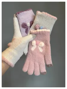 Cute winter touchscreen knit gloves for women, warm woolen mittens with sweet plush bow details.