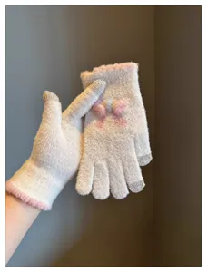 Soft knitted touchscreen gloves detail view, featuring a cute bow and warm fabric for winter.