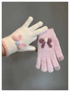 Cute knit touch screen gloves detail view, winter warm fuzzy gloves with sweet bows.