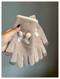 Close-up details of soft winter warm touch-screen knit gloves with cute bow design.
