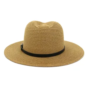 Detailed shot of a classic straw fedora hat featuring a stylish black belt and gold metal buckle.