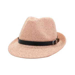 Detail view of a stylish pink straw fedora hat with black leather belt and metal buckle.