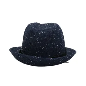 Dark blue sequin straw hat detail showcasing sparkling texture and black band accessory.