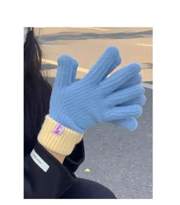 Winter warm knitted gloves with blue body and yellow ribbed cuffs for women daily wear.