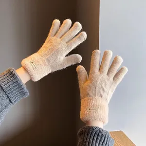 Warm winter knitted gloves for women with plush cuffs, touchscreen compatible and stylish.