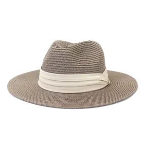 Detailed close-up of summer straw fedoras with stylish beige pleated band, breathable material.