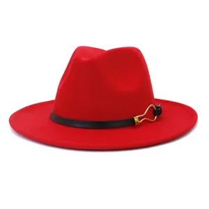 Red wool fedora hat detail, wide flat brim, elegant black leather belt with gold metal buckle.