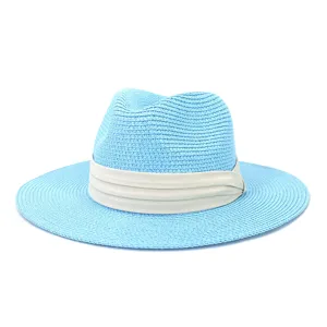 Close-up detail of light blue straw fedora hat with beige ribbon for sun protection.
