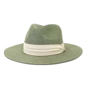 Detail view of the woven straw texture and beige pleated ribbon on the green fedora hat.