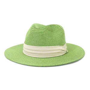 Summer green straw fedora hat detail, stylish sun protection beach cap for outdoor travel.