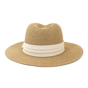 Detail view of a stylish summer straw fedora hat, perfect for outdoor travel and beach sun protection.