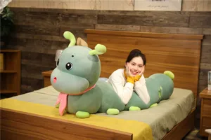 Detailed view of large green caterpillar plush toy long body pillow with cozy scarf.