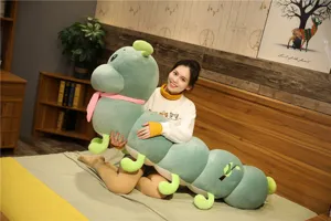 Large green caterpillar plush toy with pink scarf, soft sleeping pillow for kids and babies.