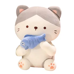 Cute sitting cat plush toy holding fish, soft stuffed animal pillow for kids and girls.