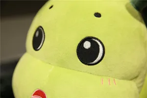 Close-up of cute green plush caterpillar head with soft fabric and delicate embroidered eyes.