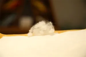 Soft white PP cotton filling material for plush toys, fluffy stuffing insert for pillows.