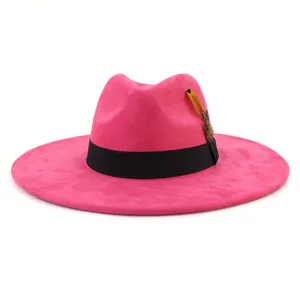 Close-up detail of the pink suede fedora, showing fine texture, elegant black band, and feather.