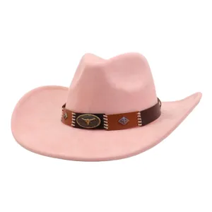Pink suede cowboy hat detail, western style fedora with brown leather band and bull skull buckle.