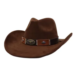 Brown suede cowboy hat detail, showing metal bull skull emblem and decorative leather hatband.