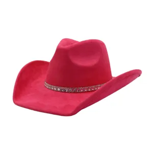 Pink suede cowgirl hat with rhinestone band, detailed close-up showing texture and sparkle.