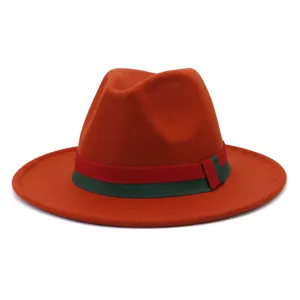 Close-up detail view of the orange wool felt fedora hat featuring a classic striped band.