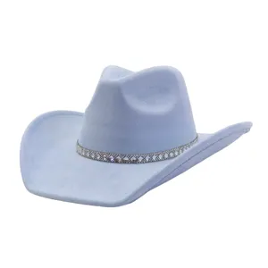 Close-up detail of light blue suede cowboy hat featuring sparkling rhinestone hat band.