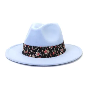 Vista detallada de un sombrero fedora de lana azul claro con una elegante banda floral negra.
