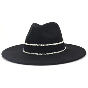 Close-up detail of the black fedora hat showcasing the elegant white beaded trim design.