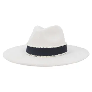 Detail view of the elegant suede fedora featuring a dark blue band with white beads.