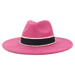 Detailed view of women suede fedora hat, featuring chic black ribbon and white beaded trim.