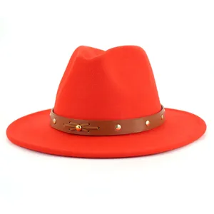 Roter Woll-Fedora-Hut Detail, zeigt braunen Ledergürtel, Nieten und vordere Schleife.