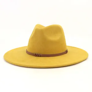 Yellow wide brim fedora hat detail, faux suede texture with brown braided band, elegant design.