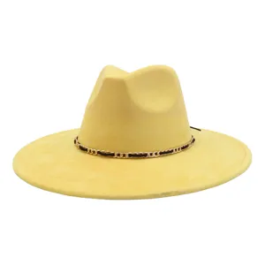 Yellow suede jazz hat detail view showing the delicate gold and black chain strap.